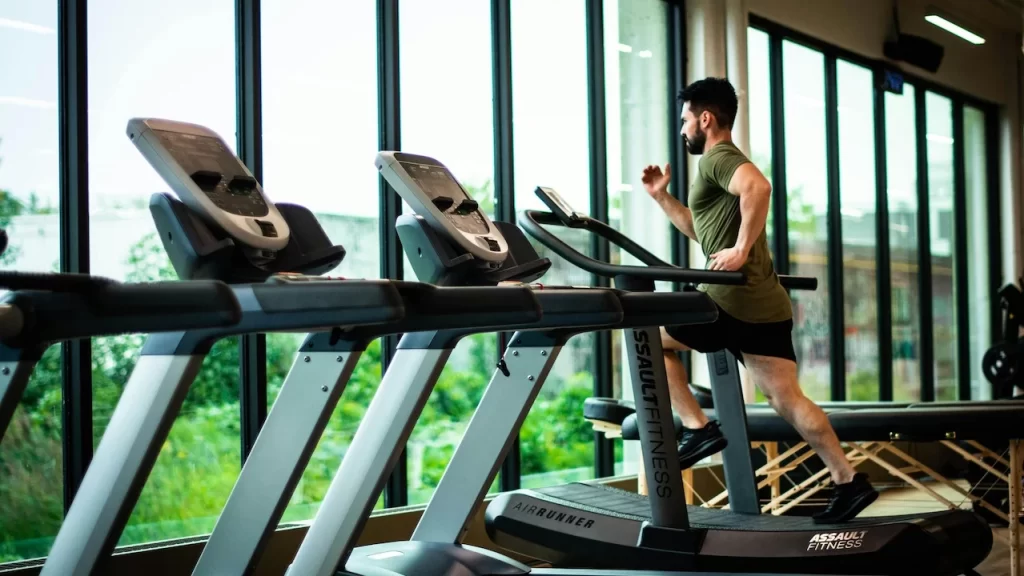 Alt Tag: Small business owner using AI dashboard to analyze gym performance and member trends